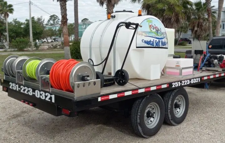 Soft wash trailer with a water tank and hose reels