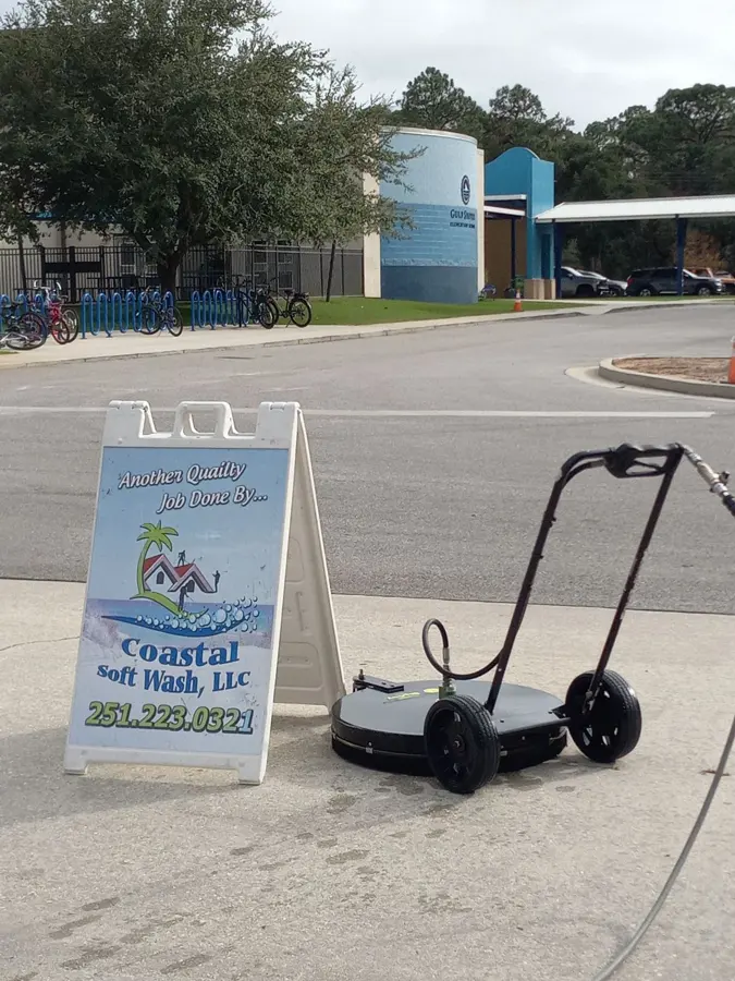 Coastal Soft Wash sign beside a surface cleaner
