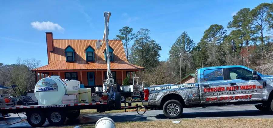 Work truck and soft wash trailer at a brick home